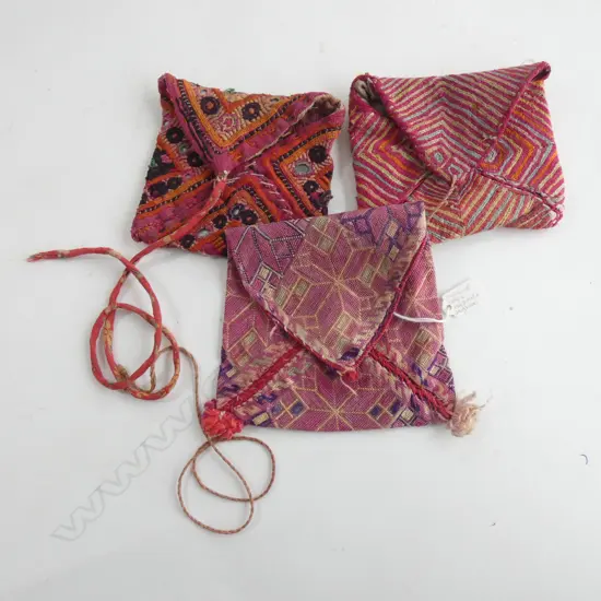 Three small ethnic make-up bags,